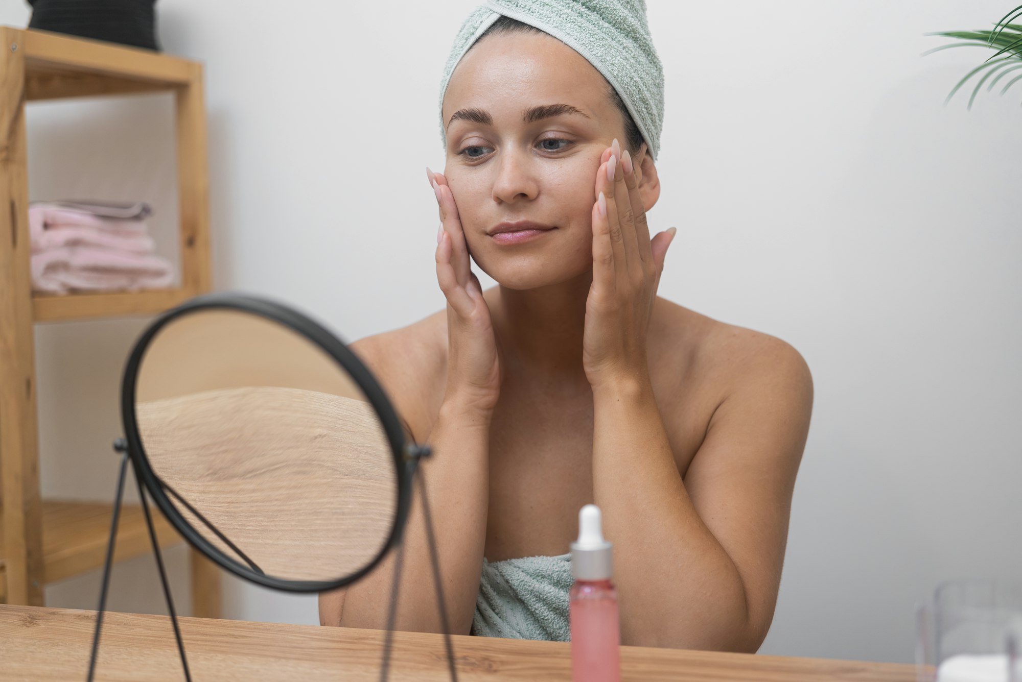Woman admiring her smooth, refreshed skin after a skincare treatment