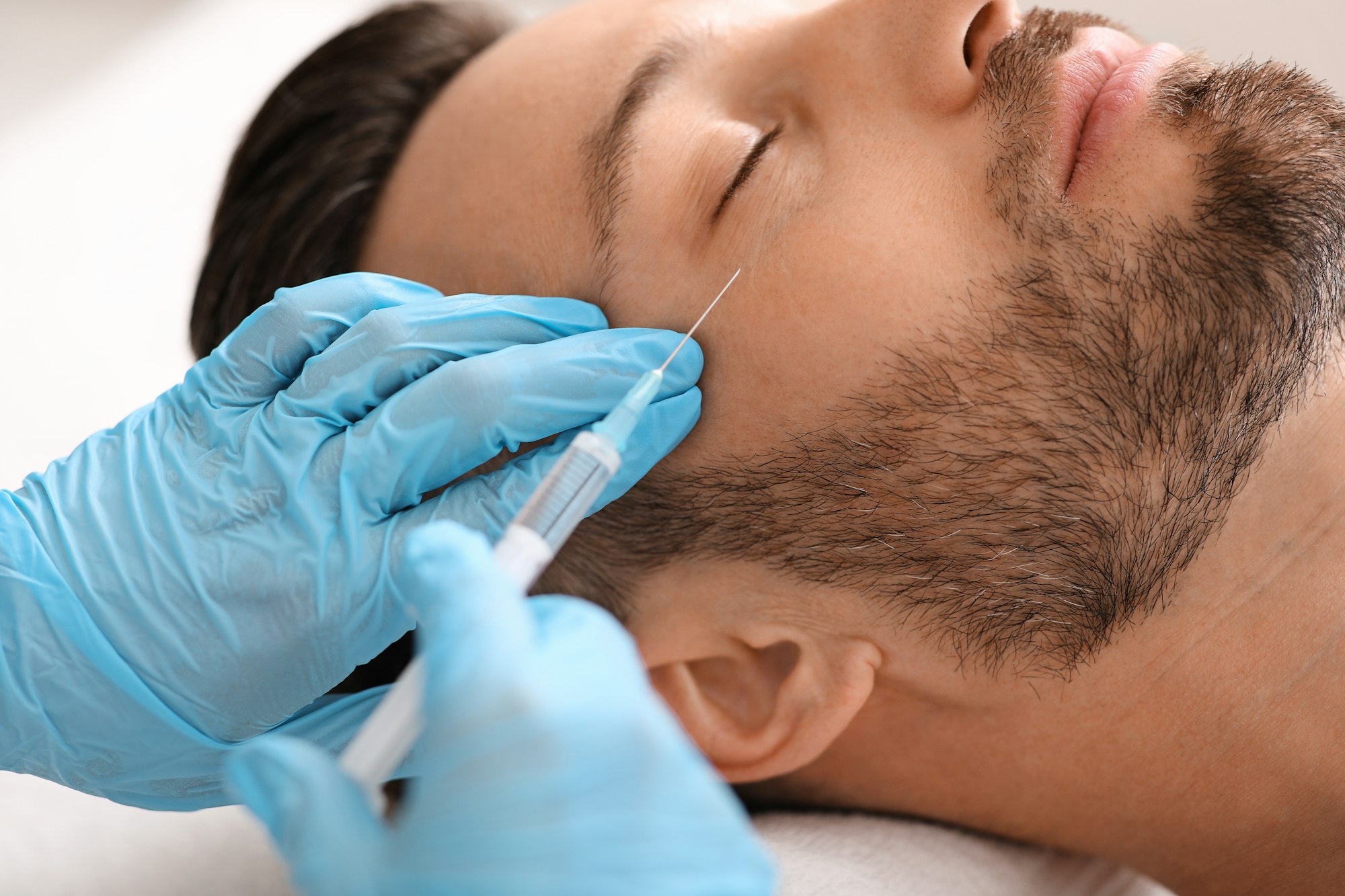 Client receiving a Xeomin anti-wrinkle injection near the eye