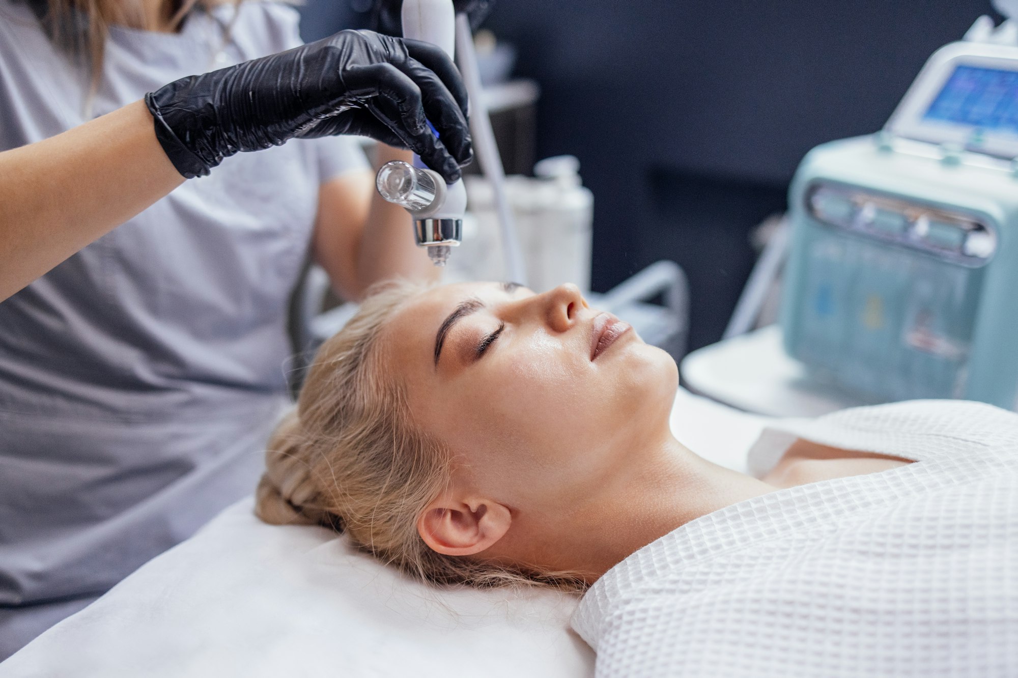 Hydrating AquaFacial cleansing and infusion treatment on a woman's skin at Hideaway Wellness & Aesthetics